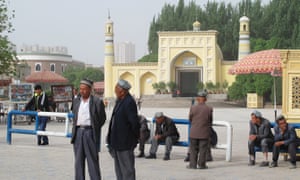 On Liberation Avenue, outside Kashgarâs Id Kah mosque, Uighur men watch security forces file past for the cityâs latest mass âanti-terrorâ rally