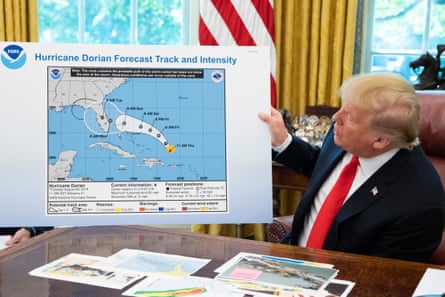 a man holds up a map that he adjusted with a marker