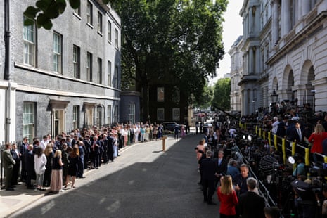 Ministers, officials and No 10 staff (on the left) and members of the media (on the right) waiting for Keir Starmer.