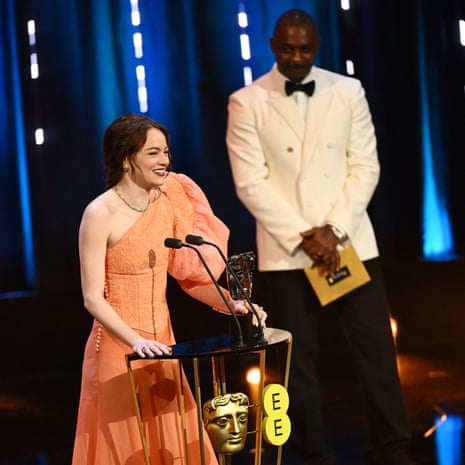 Emma Stone accepts her award.