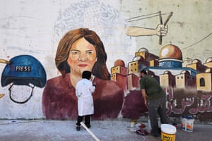 Palestinian artists paint a mural in honour of the Al Jazeera journalist Shireen Abu Akleh in Gaza City