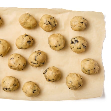 roll the dough into balls, space out on a lined baking tray, and bake.