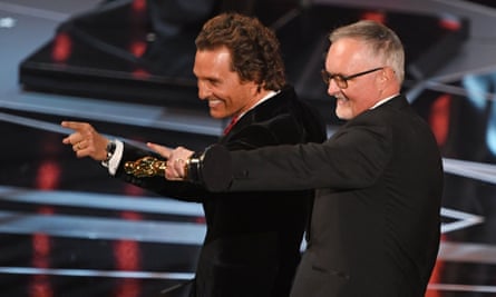 TOPSHOT - Australian Film Editor Lee Smith (R) celebrates next to US actor Matthew McConaughey after he won the Oscar for Best Film Editing for “Dunkirk”.