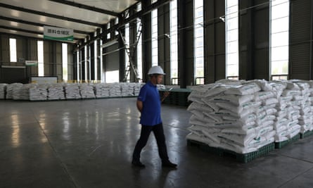 A staff member walks inside a warehouse for fertiliser products at Syngenta Group China’s warehouse in Hebei province, China.