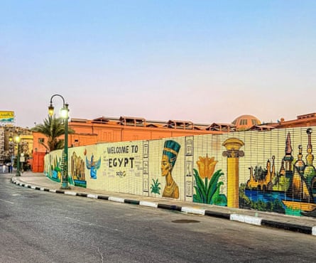 A mural with images including flowers, symbols, Queen Nefertiti and the words ‘Welcome to Egypt’