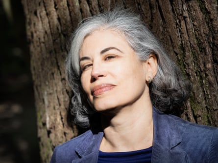 A headshot of Natasha Walter looking directly into the camera, posed against a tree.