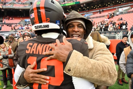 Deion Sanders hugs Shedeur before Sunday’s game against the Titans.