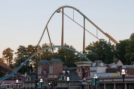 Roller coasters at Six Flags Over Georgia tower above trees and park buildings