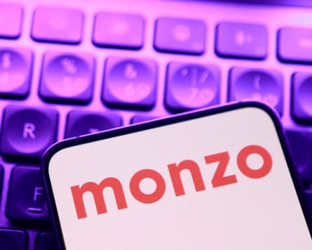 Monzo app seen on a smartphone next to a purple-hue keyboard