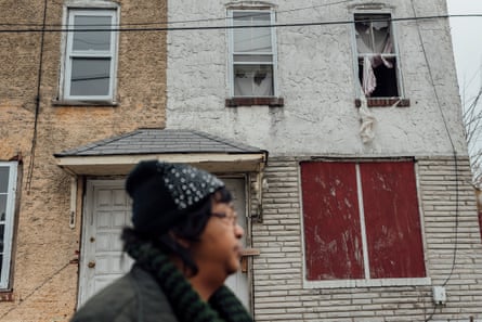 Zulene Mayfield stands in front of her old house in Chester, Pennsylvania. Mayfield moved to Delaware because she says she couldn’t live in her home anymore despite still owning it