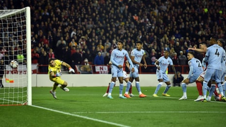 Nottingham Forest's Emmanuel Dennis heads home to open the scoring in their Premier League game against Aston Villa.