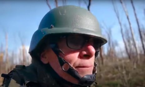 Documentary maker Sean Langan wearing a military helmet while travelling with Russian soldiers to make his film about the Russia-Ukraine war.