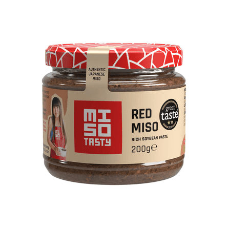 A jar of Miso Tasty Red Miso paste with a red patterned lid and tan label