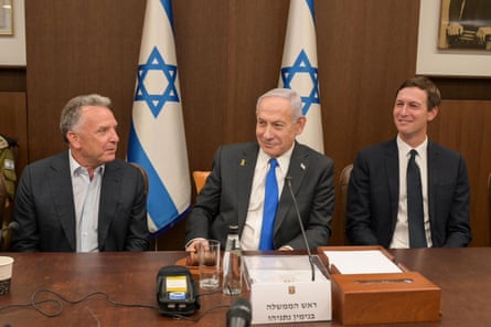Witkoff, Netanyahu and Kushner sit behind a desk with a pair of Israel flags behind them