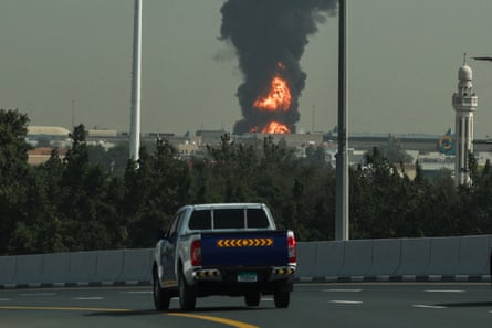 Smoke and flames billow above Dubai airport.