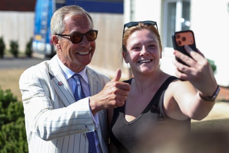 Farage posing for a picture with a woman.