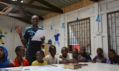 Samson Otieno, aged 22, teaching young boys in Kibera