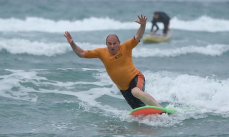 Ed Davey falls from a surfboard during a visit to Big Blue Surf School in Bude in Cornwall.