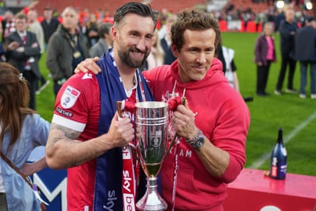 Wrexham co-owner Ryan Reynolds (right) and Ollie Palmer with the League One trophy in April 2025
