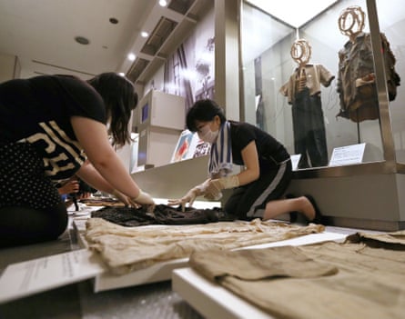 Staff at the Hiroshima Peace Memorial Museum clean exhibits before the 70th anniversary of the bombing last July