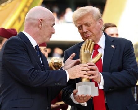 Donald Trump looks over the golden glove with Fifa president Gianni Infantino after the Club World Cup final