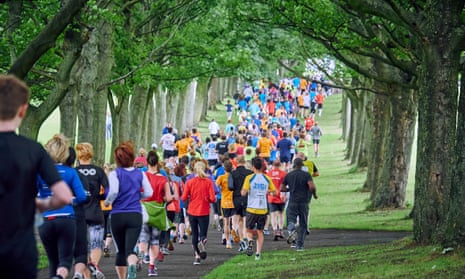 Runners in a wooded area of Woodhouse Moor, Leeds, taking part in a communal Parkrun.
