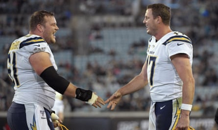 Philip Rivers, right, celebrates with center Scott Quessenberry. But how much longer will Rivers be with the Chargers?