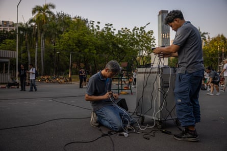 Staff setting up microphones and audio equipment