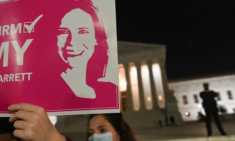 An Amy Coney Barrett supporter holds aloft a poster outside the supreme court in October. The Christian right could be further emboldened after her controversial appointment.