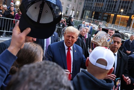 a man stands in front of a group of people