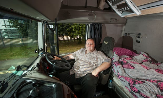HGV driver Mark Hughes in the cab of his lorry.