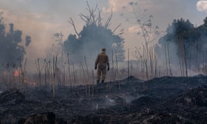 A firefighter combats a fire in the the Sorriso municipality, Mato Grosso state, Brazil, on 26 August.