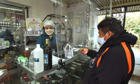 A man buys chlorine dioxide in a pharmacy in Cochabamba, Bolivia.