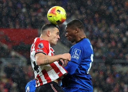 Granit Xhaka challenges for the ball in the air with Bafodé Diakité.