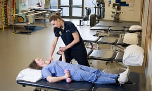 Physiotherapist Lauren Castledine-Wolfe treats a staff member at Kingston hospital in south London.