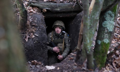 A Ukrainian serviceman looks out from an underground shelter on the frontline near the town of Bakhmut, Donetsk region.