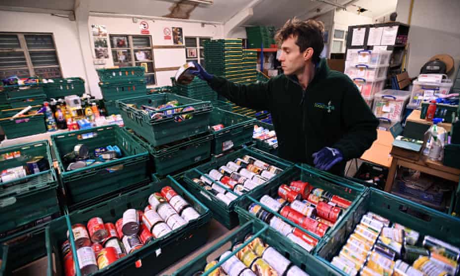 A worker at a food bank in Peckham, London, prepares emergency food parcels.