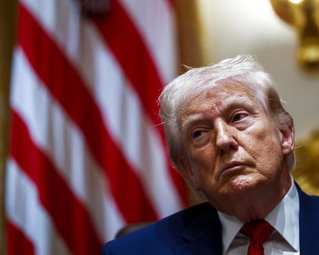 Donald Trump with a US flag behind him