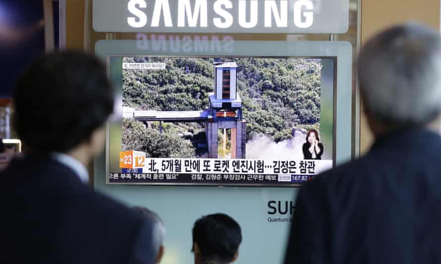 People watch a TV news showing an image that North Korea’s Rodong Sinmun newspaper reports of the ground test of a high-powered engine of a carrier rocket at the country’s Sohae Space Centre in Seoul, South Korea.