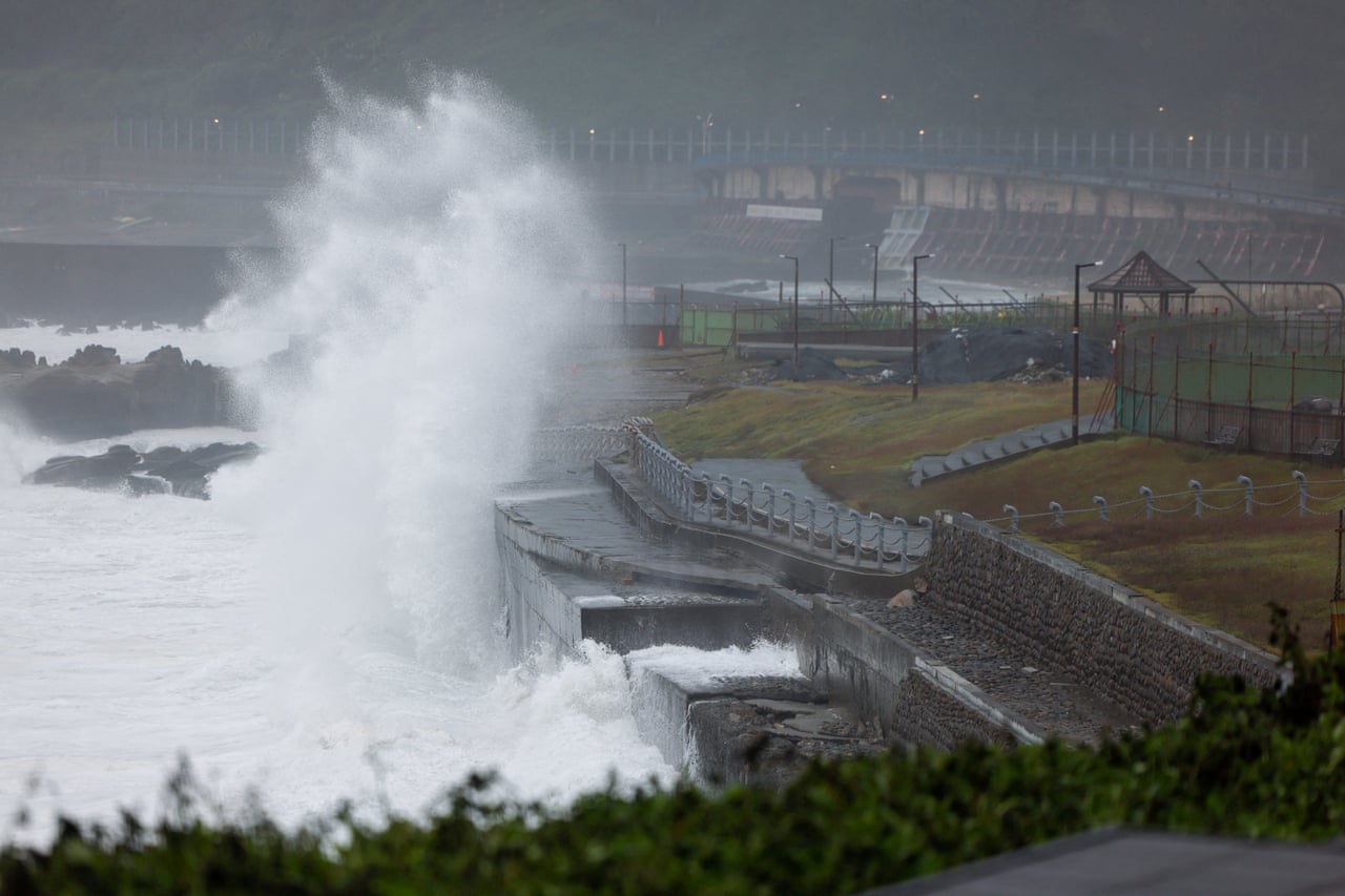 Waves generated by Typhoon Champi crash against a seawall in Keelung