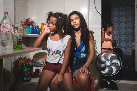Anna Gabriela Patrocinio Gregório, 24, her daughters Lara, 8, and Sãnella, 5, pose for a portrait at their home in a favela located in the Santa Teresa neighborhood in Rio de Janeiro