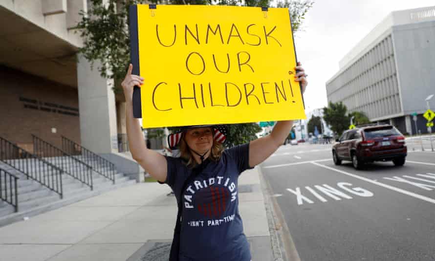 A person protests against school mask warrants in Tampa in May.