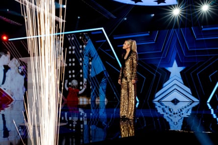 a woman stands on stage