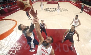 Iran’s Hamed Haddadi is fouled by France’s Vincent Poirier