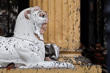 A damaged statue of a lion