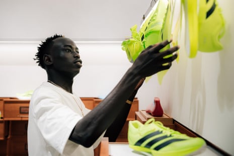 Gout Gout looks at a pair of shoes before his a panel talk organised by Adidas at the World Athletics Championships in Tokyo