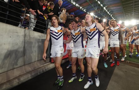Nat Fyfe, Caleb Serong and Hayden Young walk from the field with Fremantle teammates