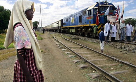 A Kenyan girl looks at the “Lunatic Express” on its way from Mombasa to Kisumu for the 100th anniversary of the Uganda Railway in 2001.