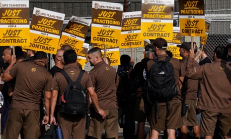 UPS workers walk a 'practice picket line' on 7 July in Queens, New York, ahead of a possible strike.