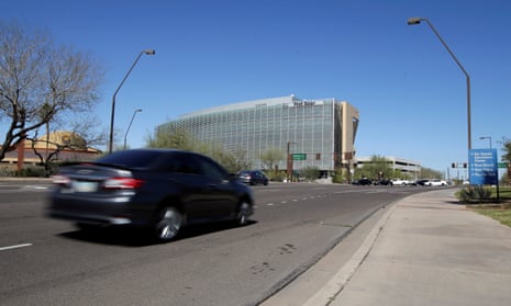 A car passes the location where a woman pedestrian was struck and killed by an Uber self-driving sport utility vehicle in Tempe, Arizona, on Monday.